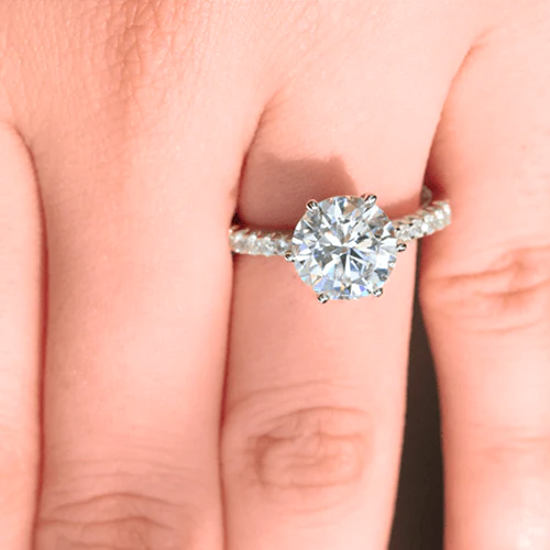 3 carat round pave diamond ring on finger